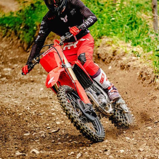biker riding motorbike on dirt trail wearing sidi crossair x motorcycle boots uk