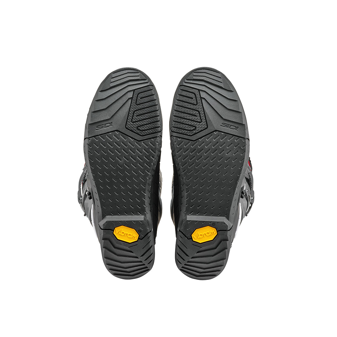 black soles of a pair of black and grey Sidi motorcycle boots