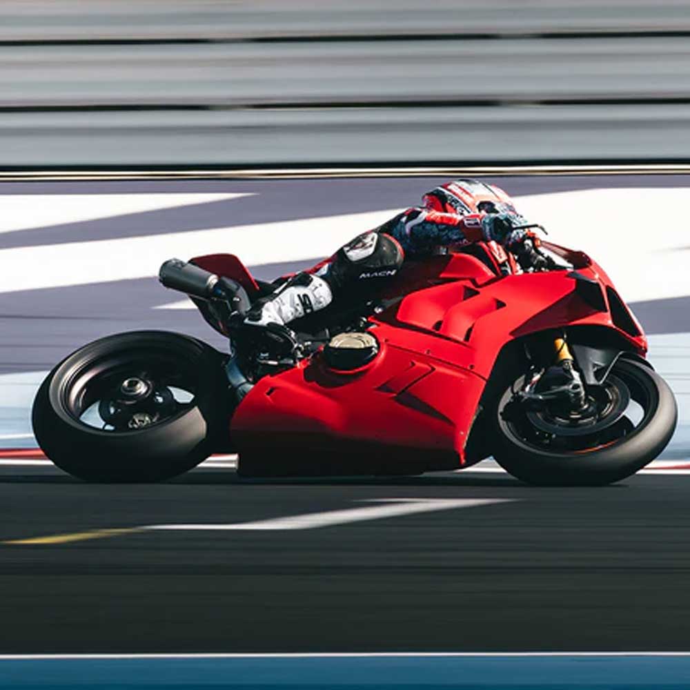 biker in motorbike race riding red and black motorcycle