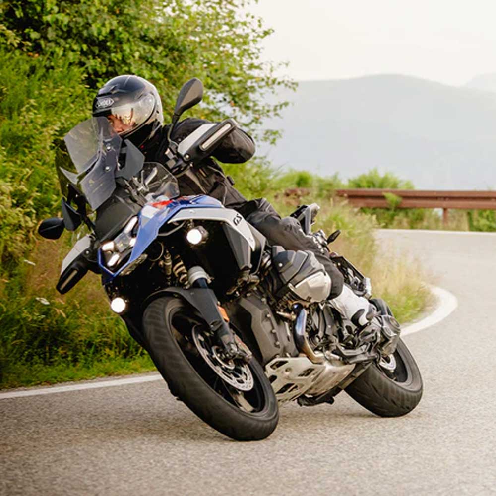 biker riding motorcycle in full protective gear