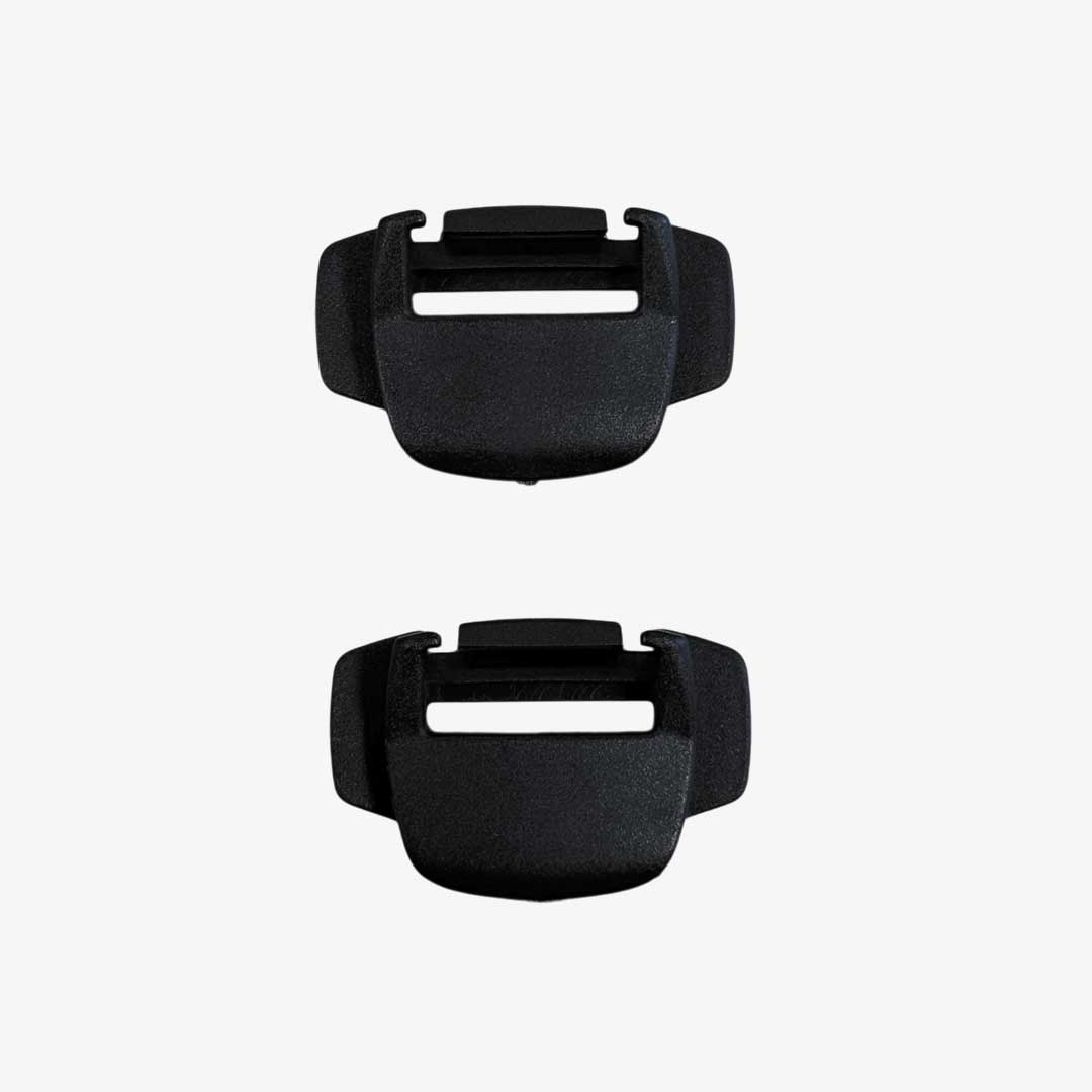 Two black plastic buckles on a white background