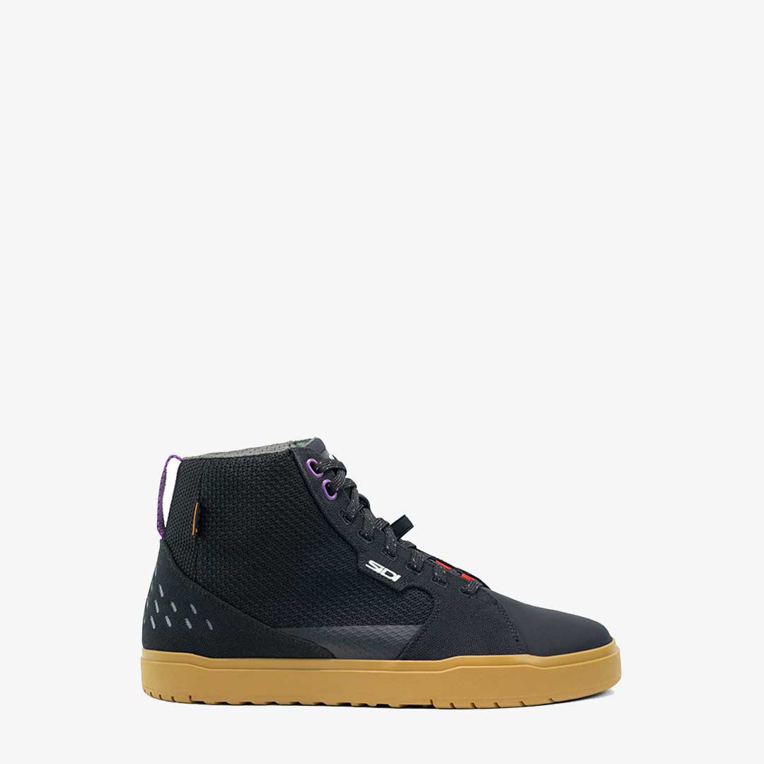 side view of black motorbike high top trainers