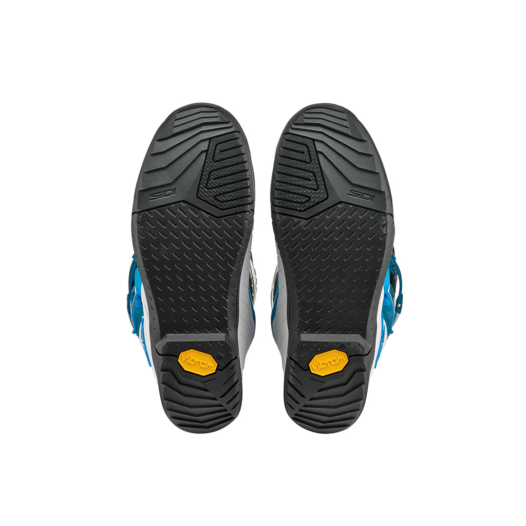 black soles of a pair of White and Petrol blue Sidi boots
