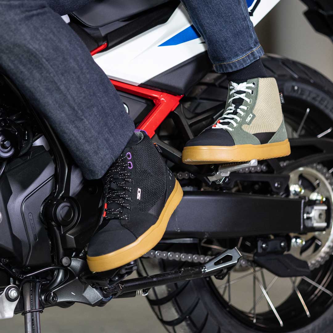 biker couple wearing matching high top motorbike trainers