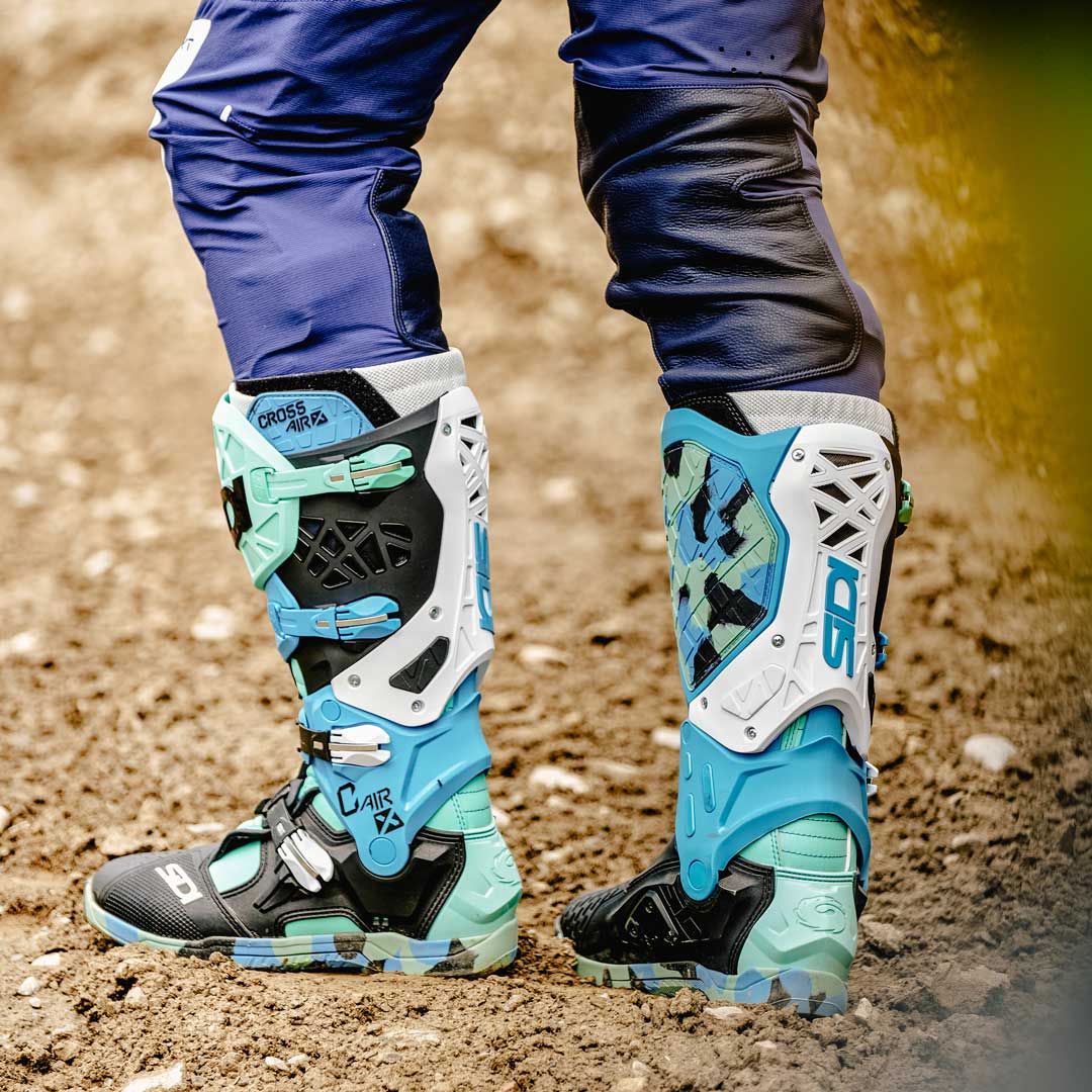 pair of blue white and green sidi motorcycle boots