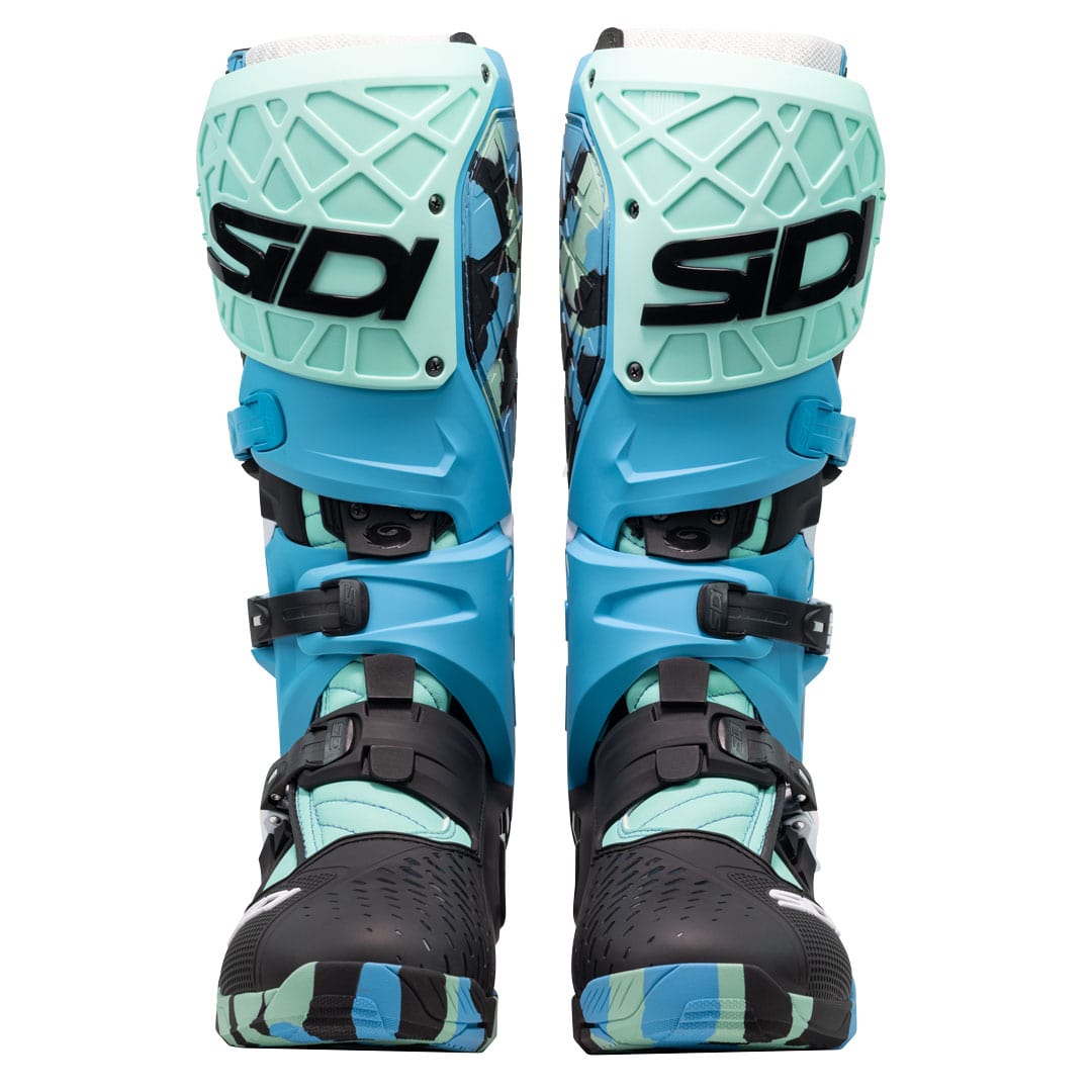 front of a pair of green blue and black motorcycle boots with sidi logo