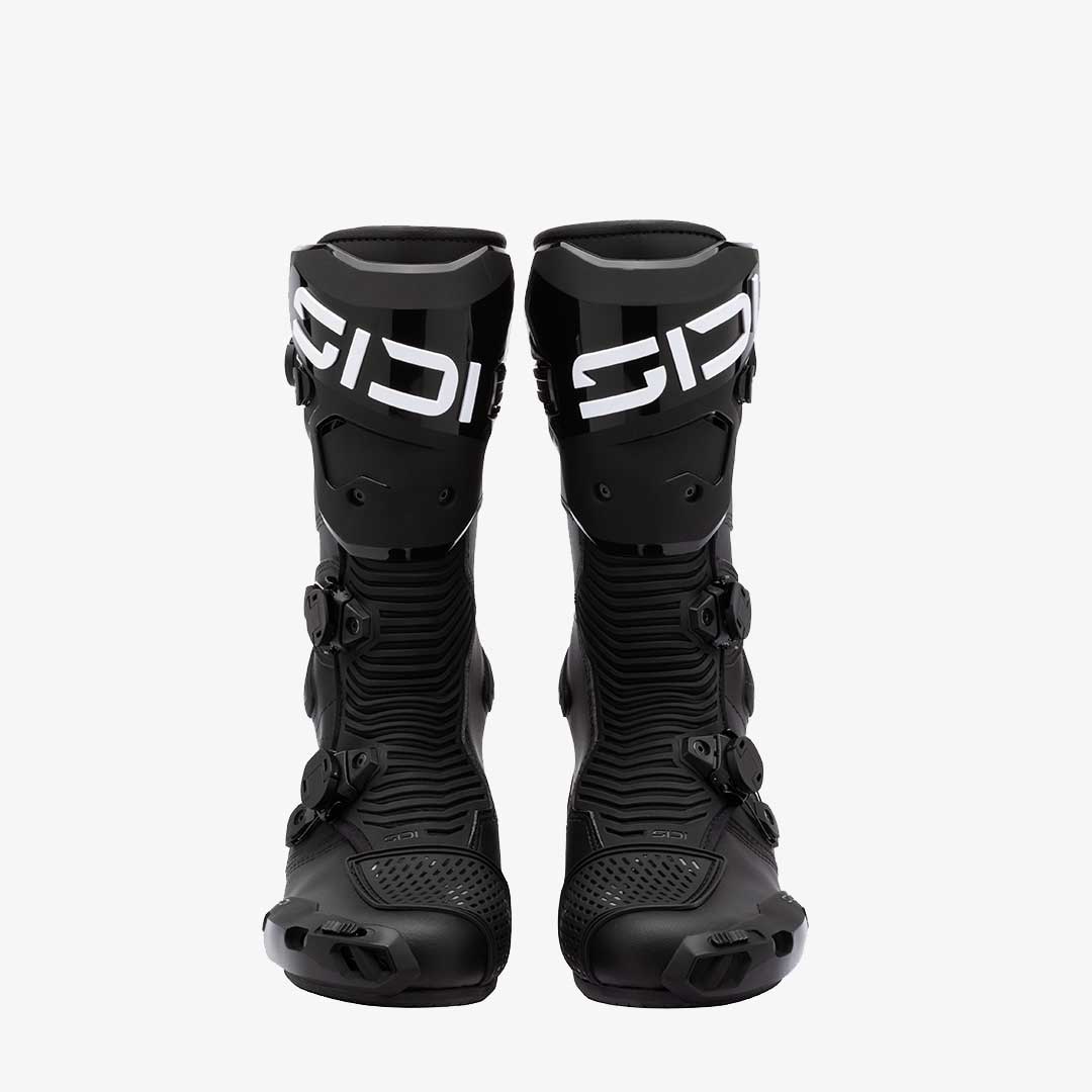 Pair of black motocross boots with 'Sidi' branding on a white background