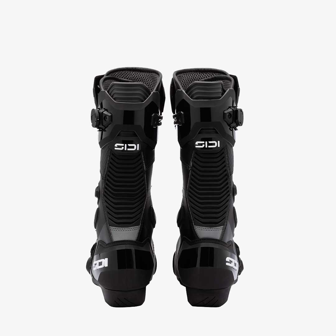 Pair of black motocross boots with Sidi branding on a white background