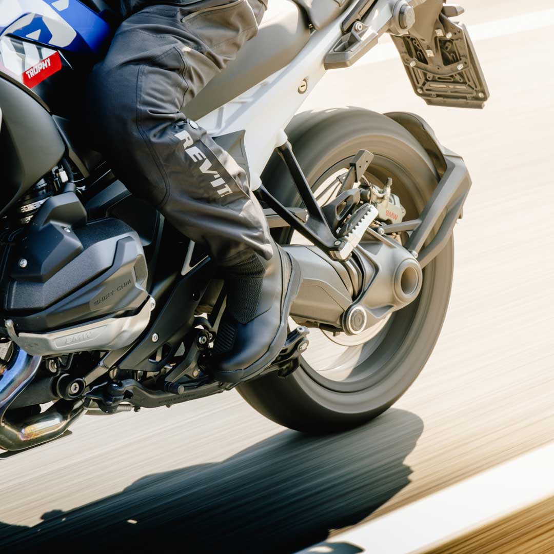 biker riding motorbike wearing black gear and black orion motorcycle boots