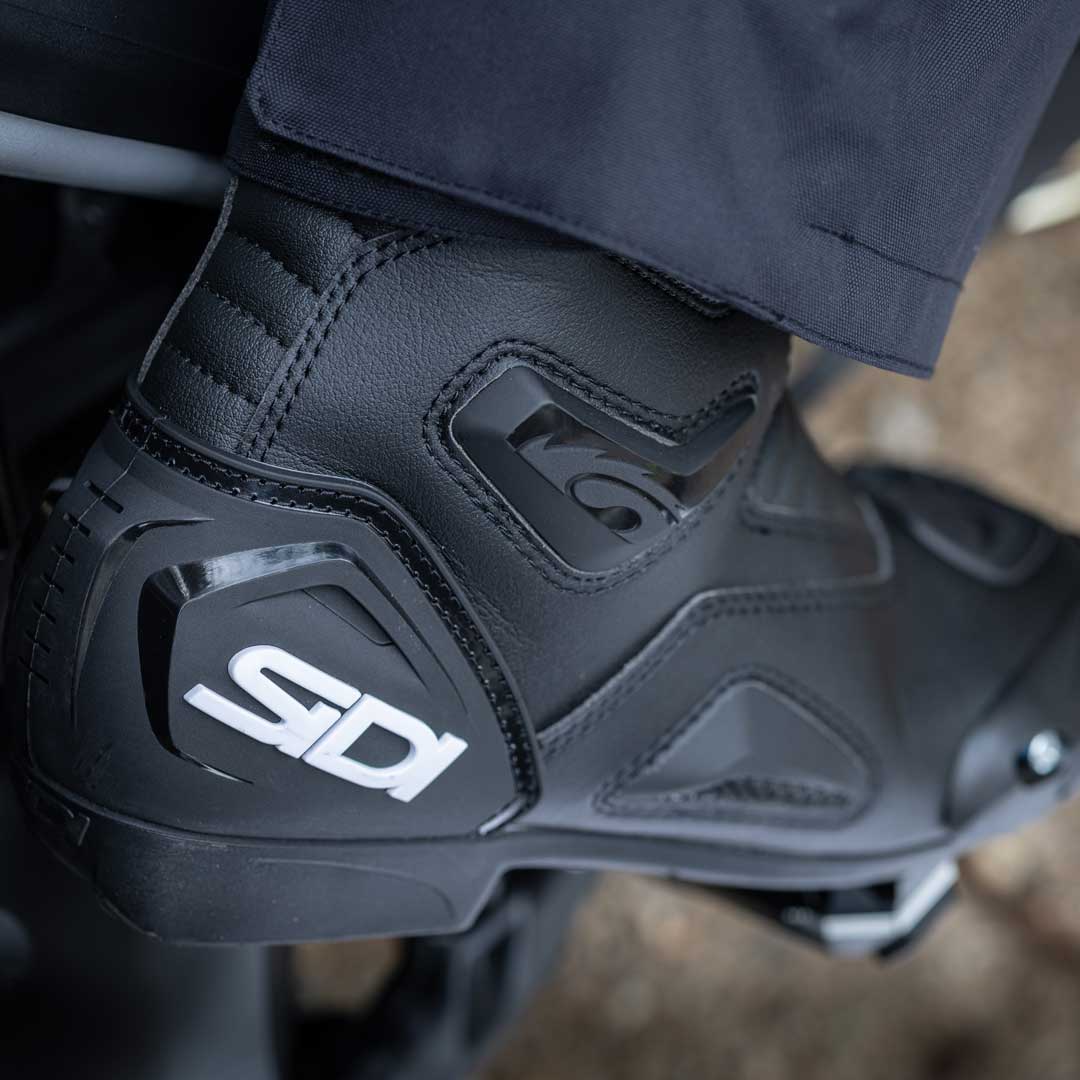 Close-up of a black Sidi motorcycle boot on a blurred background