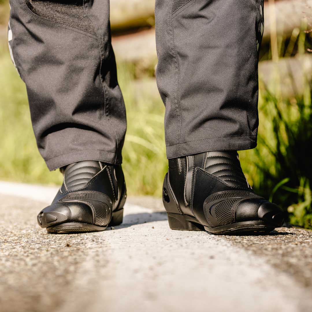 biker wearing black performer gore motorcycle sidi boots