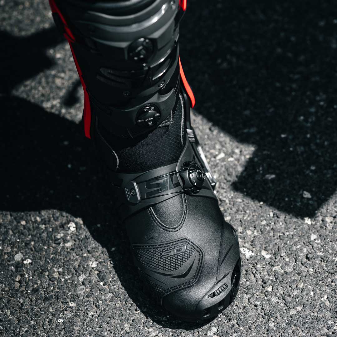 closeup of black and red motorbike boots