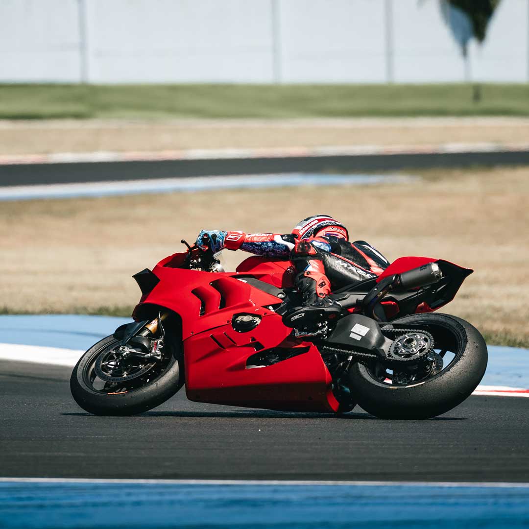 sport racer on red motorbike wearing red and black gear