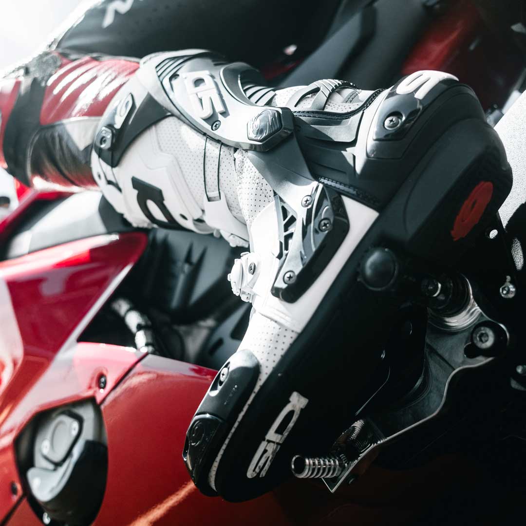 white and black road riding motorcycle boot