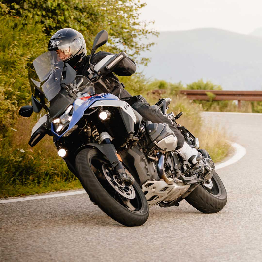 biker on open road riding motorcycle in motorcycle gear