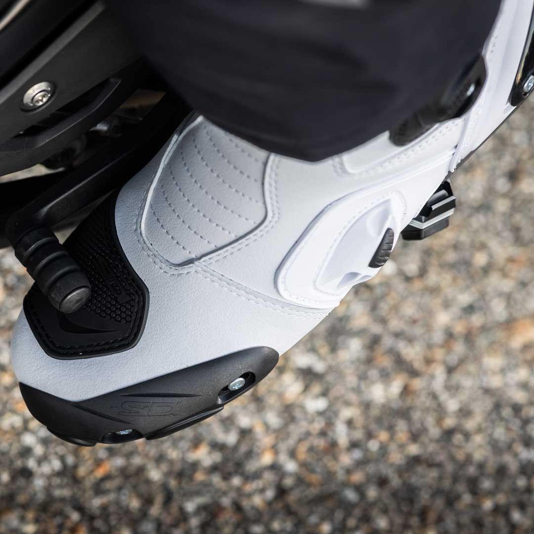 closeup of toe and gear panel on white motorbike shoes