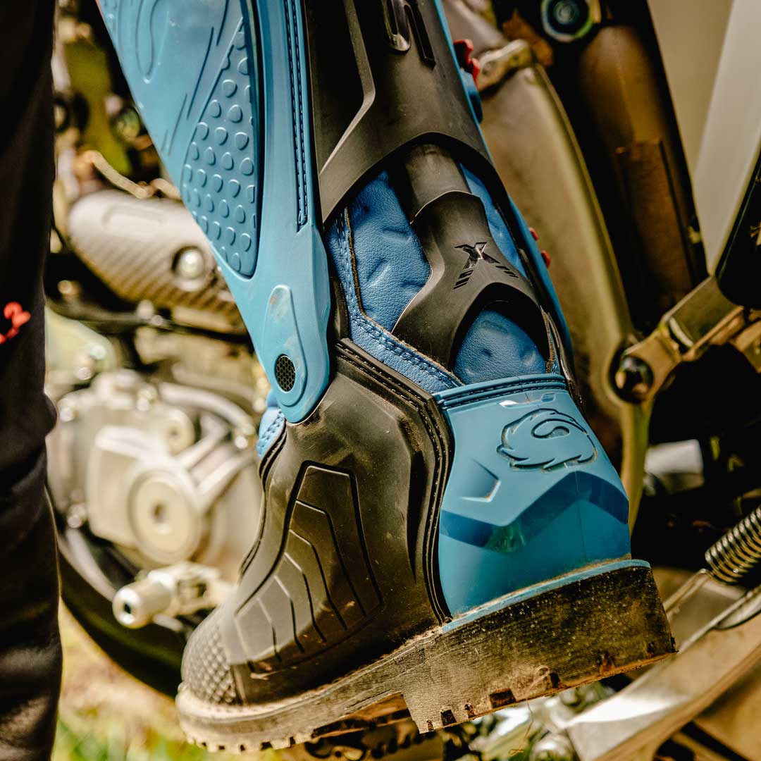back of blue and black motorcycle boots